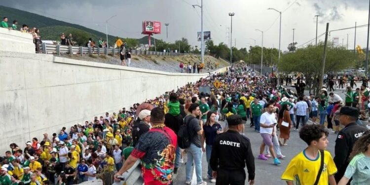 Caravana-sueca-en-monterrey - Entre Regios Large Crowd Walking Along a Closed Road, Many in Green/yellow Shirts, with Onlookers Atop a Concrete Barrier. - Entre Regios