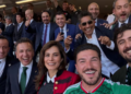 Group Selfie of Smiling Professionals at a Formal Event, with a Woman in a Red Jacket and a Man in a Green Jersey in Front. - Entre Regios